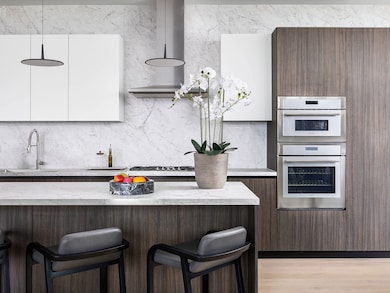 The gourmet kitchen boasts custom PEDINI cabinetry