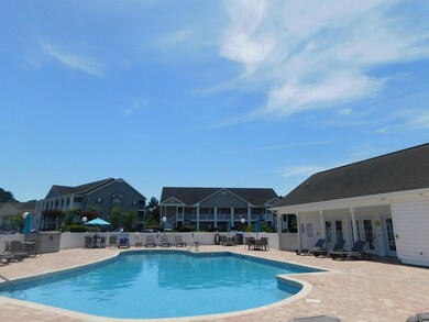 Community pool with fence and a patio area