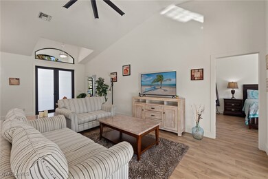 Living room featuring french doors, light hardwood