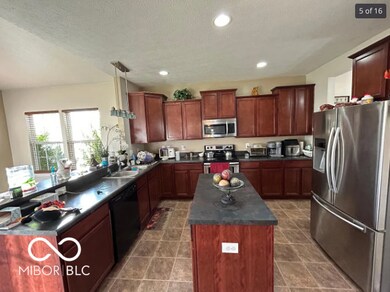 kitchen with appliances with stainless steel finishes, dark countertops, recessed lighting, pendant lighting, and a textured ceiling