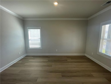 Empty room with baseboards, ornamental molding, vi