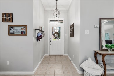 Entrance foyer featuring baseboards, crown molding