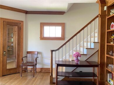 Attractive staircase at the north end of the living room. Hardwood floors.