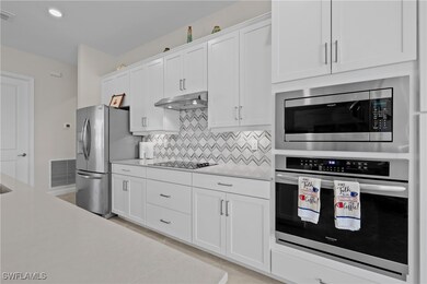 Kitchen with stainless steel appliances, tasteful