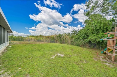 Fenced backyard with a playground