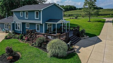 Side of the home with large deck and beautiful lan