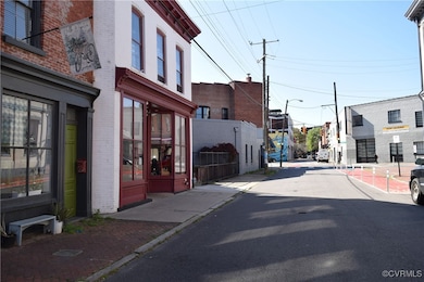 View of street featuring curbs, street lighting, and sidewalks