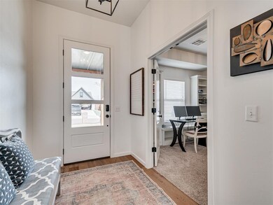 Foyer featuring wood finished floors and baseboards