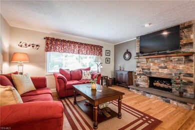 Bamboo flooring and a stone fireplace with gas logs