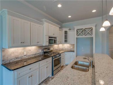 Kitchen. Gourmet kitchen with granite counter tops, custom painted cabinets tumbled tile backsplash and  stainless steel appliances.