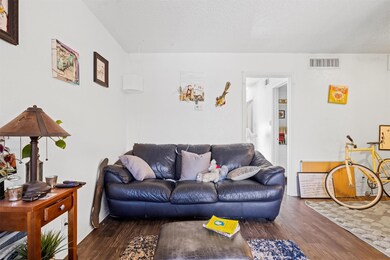 Living room featuring a textured ceiling, wood fi
