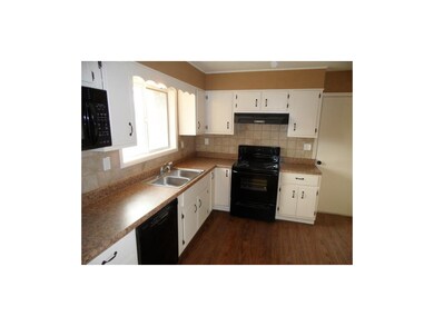 Spacious kitchen with new counter tops, and tiled 