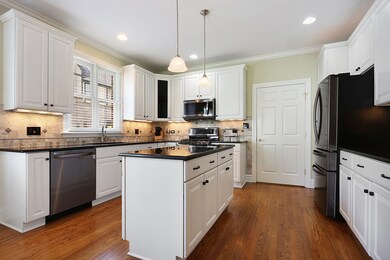 kitchen with custom cabinets, new appliances, cent