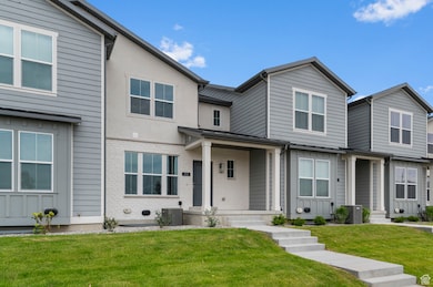 Multi unit property with a front yard and brick siding