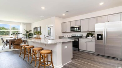 Kitchen featuring sink, light stone counters, gray