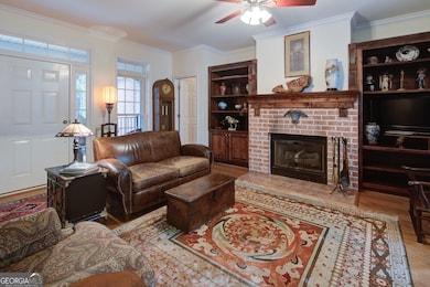 Welcome to nine foot ceilings throughout the house and shiny hardwood floors.  A brick surround enhances the gas log fireplace.