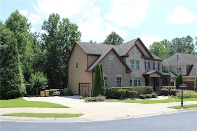 Craftsman house with an attached garage, concrete driveway, and stone siding