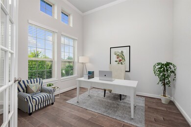 Study with tall ceilings, crown molding and double