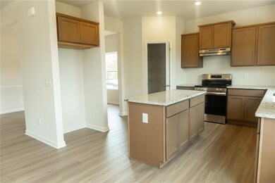 Kitchen featuring light wood-type flooring, stainl
