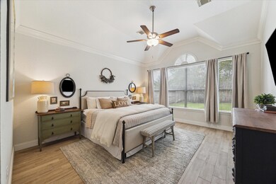 Elegant primary suite features high ceilings, crow