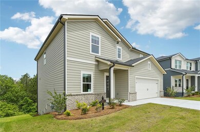 View of front facade featuring driveway, a front y