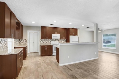 Kitchen with beautiful 42 inch cabinets, granite countertops and beautiful backsplash