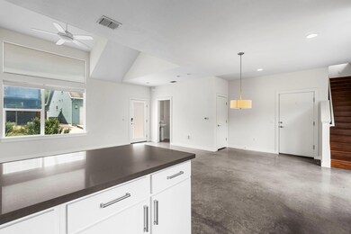 Kitchen with ceiling fan, visible vents, finished