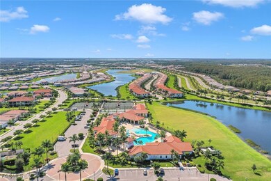Aerial view of residential area with a pool and a large body of water