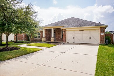 A double-wide driveway leads to the 2-car attached garage, complete with dual sconce lighting, an automatic garage door opener, and interior wheelchair ramp for plenty of convenient parking.