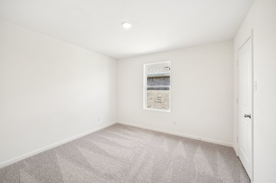 Carpeted spare room featuring baseboards and recessed lighting