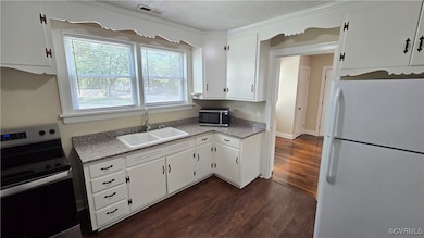 Kitchen featuring stainless steel appliances, a si