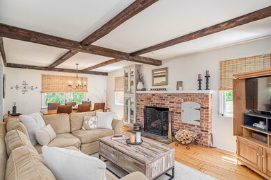 Spacious living room with wood fireplace, with a charming coffered ceiling