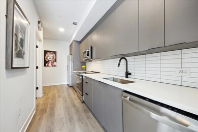 Kitchen with stainless steel appliances, gray cab