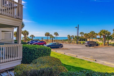 Uncovered parking lot featuring a water view