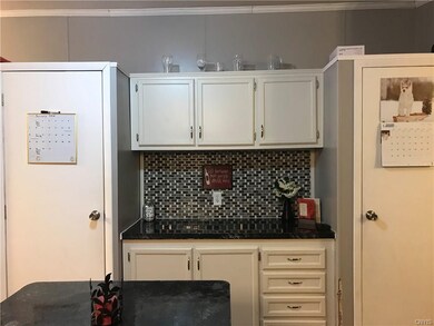 Kitchen with pantry space to right & left of count