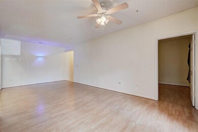 Empty room featuring ceiling fan, a textured ceili