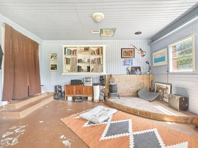 Living room featuring crown molding