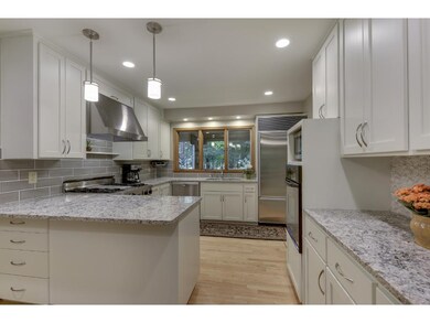 Beautifully updated kitchen with gleaming quartz c