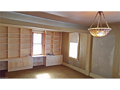 Notice full wall of built-in bookcases with desk a