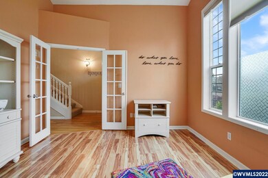 Main level office with French doors and vaulted ce