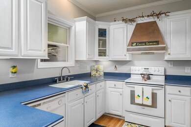 Window over sink with ample cabinet & countertop space.
