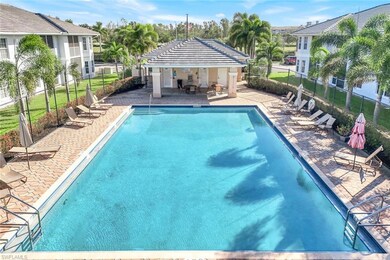Community pool with a patio area and fence