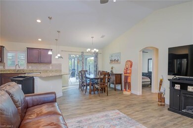 Living room with high vaulted ceiling, sink, light