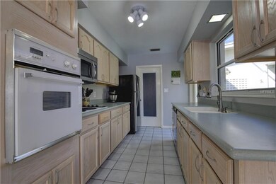Galley style kitchen leads to oversize 2 car garag