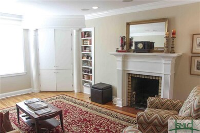 Living room with fireplace, built-ins and wood flo
