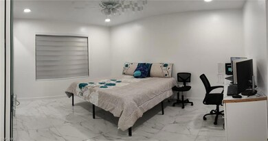 Bedroom featuring marble look tiles, recessed ligh