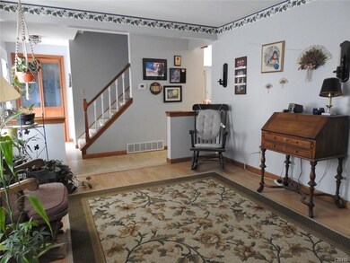 Livingroom looking back to front entrance and stairway to upstairs.