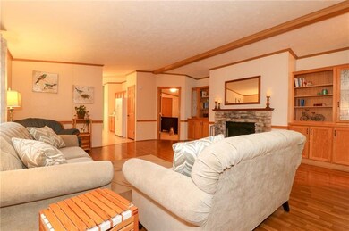 THE LIVING ROOM WITH VAULTED CEILING, WARM HARDWOO
