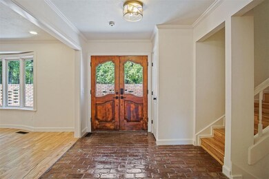 Foyer featuring french doors, crown molding, and d