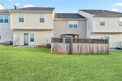 Rear view of property with a yard, cooling unit, a